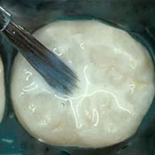 An image of a cake batter being mixed with a wooden spoon.