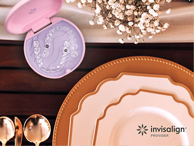 An advertisement featuring a table setting with plates, cutlery, and a toothbrush holder, emphasizing dental hygiene products.